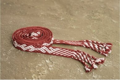 Tablet woven wool band with sign of snake that was found in Paragaudis grave in red background